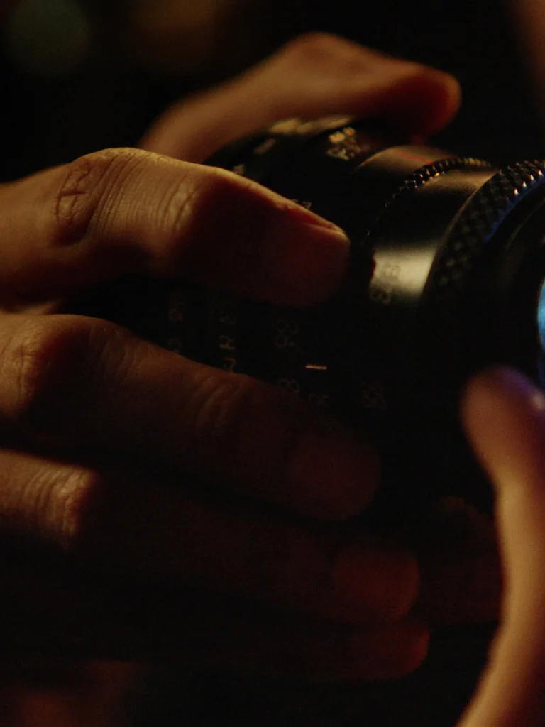 Hands on a cinema camera focus ring